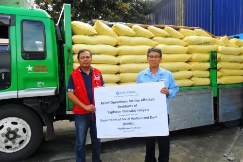 HHIC-Phil managing director Joong Gyu Kim (right) turns over the company's P4-million rice donation for victims of Typhoon Yolanda to the Department of Social Welfare and Development.