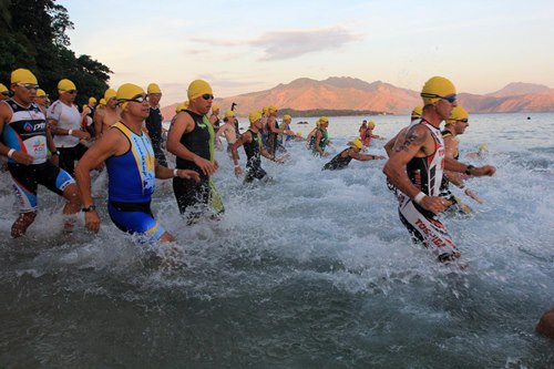 Local and foreign triathletes dash to the waters of Camayan Beach in the Subic Bay Freeport for the 1.9-kilometer swim leg of the first Challenge Philippines Triathlon held on Saturday.