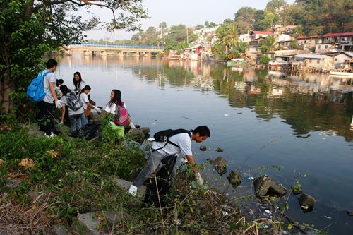 Volunteers from the Subic Bay Metropolitan Authority, locator-companies in the Subic Bay Freeport, and barangays and schools in Olongapo City scour the riverside for garbage during a clean-up project last Saturday.