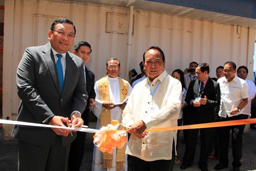 Cabinet Secretary Jose Almendras (left) and SBMA Chairman and Administrator Roberto V. Garcia prepare to cut the ceremonial ribbon to officially open the One-Stop-Shop at the New Container Terminal-1 to fast-track port transactions inside Subic Bay Freeport Zone.