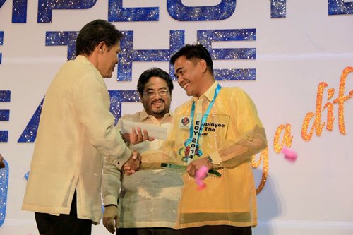 Engr. Aldrin Sadang of the SBMA Aviation and Maritime Operations Group receives his trophy from Atty. Ramon Agregado, SBMA Senior Deputy Administrator for Support Services while SBMA Director Benjamin Antonio III watches, after besting other finalists during the search for the 2014 Employee of the Year held at the Subic Bay Exhibition and Convention Center.