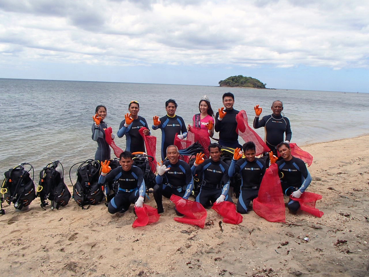 Volunteer divers, along with Miss Subic Bay Tourism first runner-up Martina McKinsey, prepare for a scuba dive to collect non-biodegradable waste materials around Grande Island, a popular resort in Subic Bay Freeport.