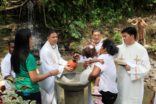 Members of the indigenous Pastolan Ayta tribe line up to receive the sacrament during a mass baptism held on Saturday at the Holy Land Sanctuary and Biblical Theme Park in the Subic Bay Freeport.
