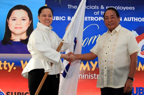 Former SBMA Chairman & Administrator Roberto V. Garcia officially hands over the agency flag to new Administrator & CEO, Atty. Wilma "Amy" T. Eisma during the turnover ceremony