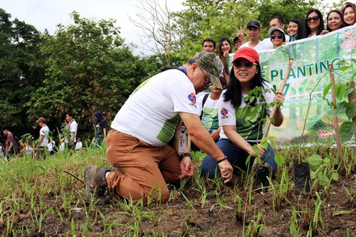 SBMA Administrator and CEO Wilma T. Eisma and SBMA Director Tomas Lahom III lead employees in a tree-planting activity in the Subic Bay Freeport in observance of Arbor Day last Friday