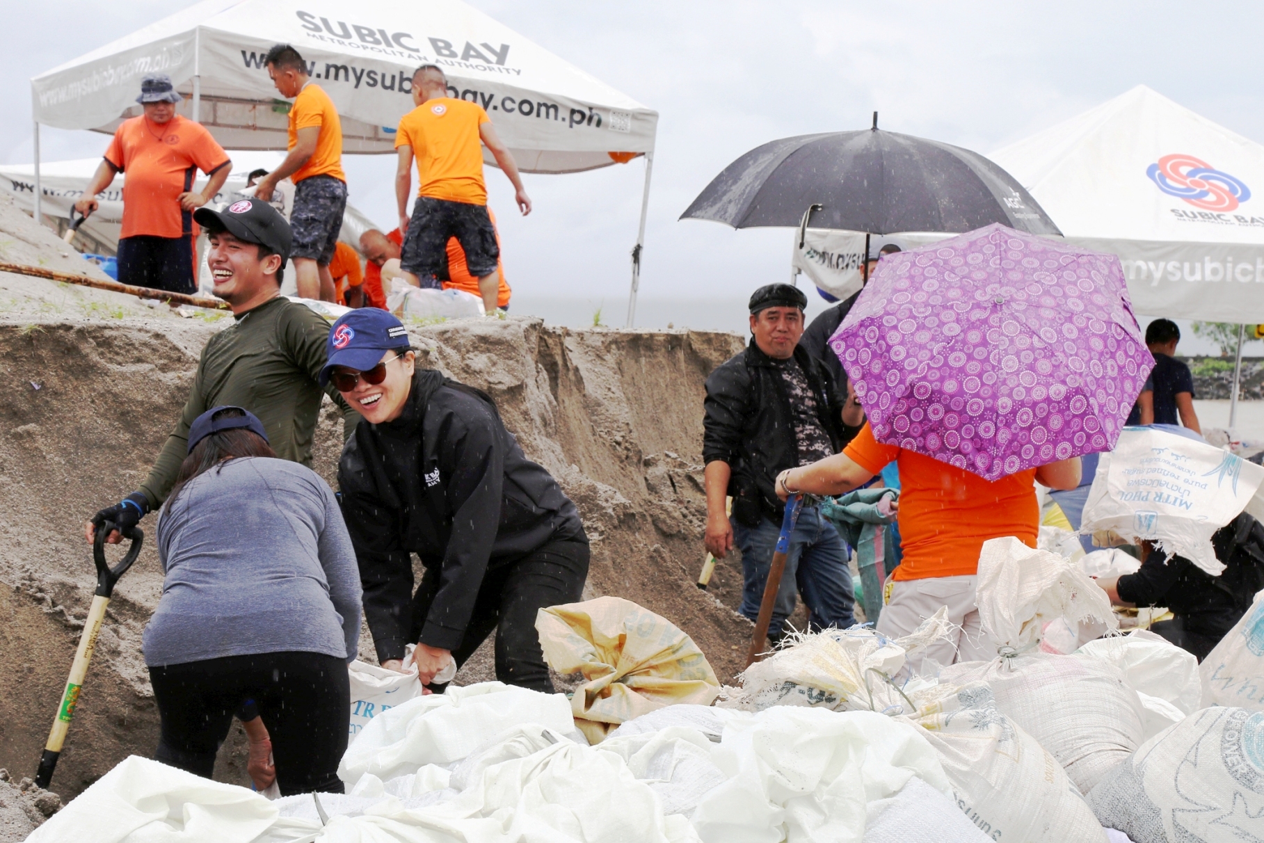SBMA Chairman and Administrator Wilma T. Eisma joins volunteers in filling sandbags for use in slope protection at erosion-prone areas in the Subic Bay Freeport Zone.