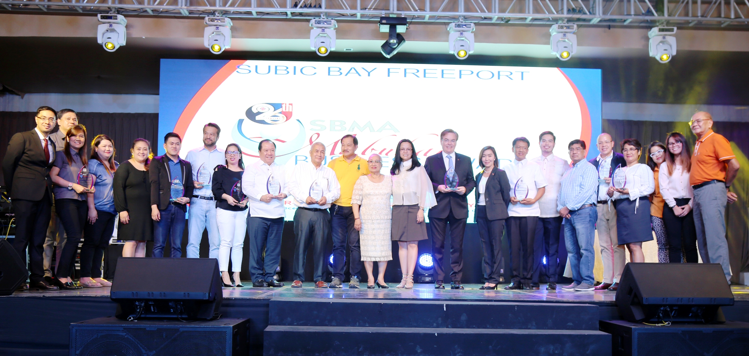 SBMA Chairman and Administrator Wilma T. Eisma (center) joins other SBMA officials in congratulating winners of the SBMA Mabuhay Awards, which recognized top corporate performers in the Subic Bay Freeport Zone