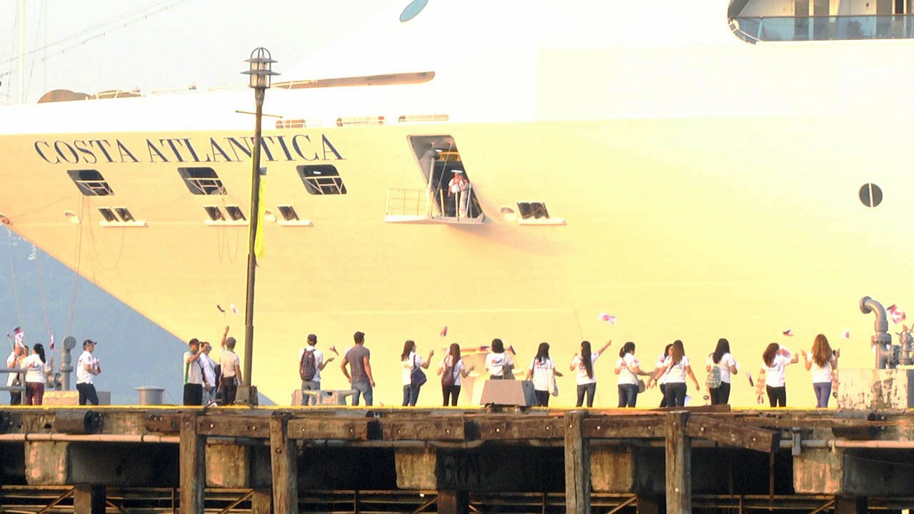 SBMA employees line up along Alava Wharf to welcome the arrival of the cruise ship Costa Atlantica.