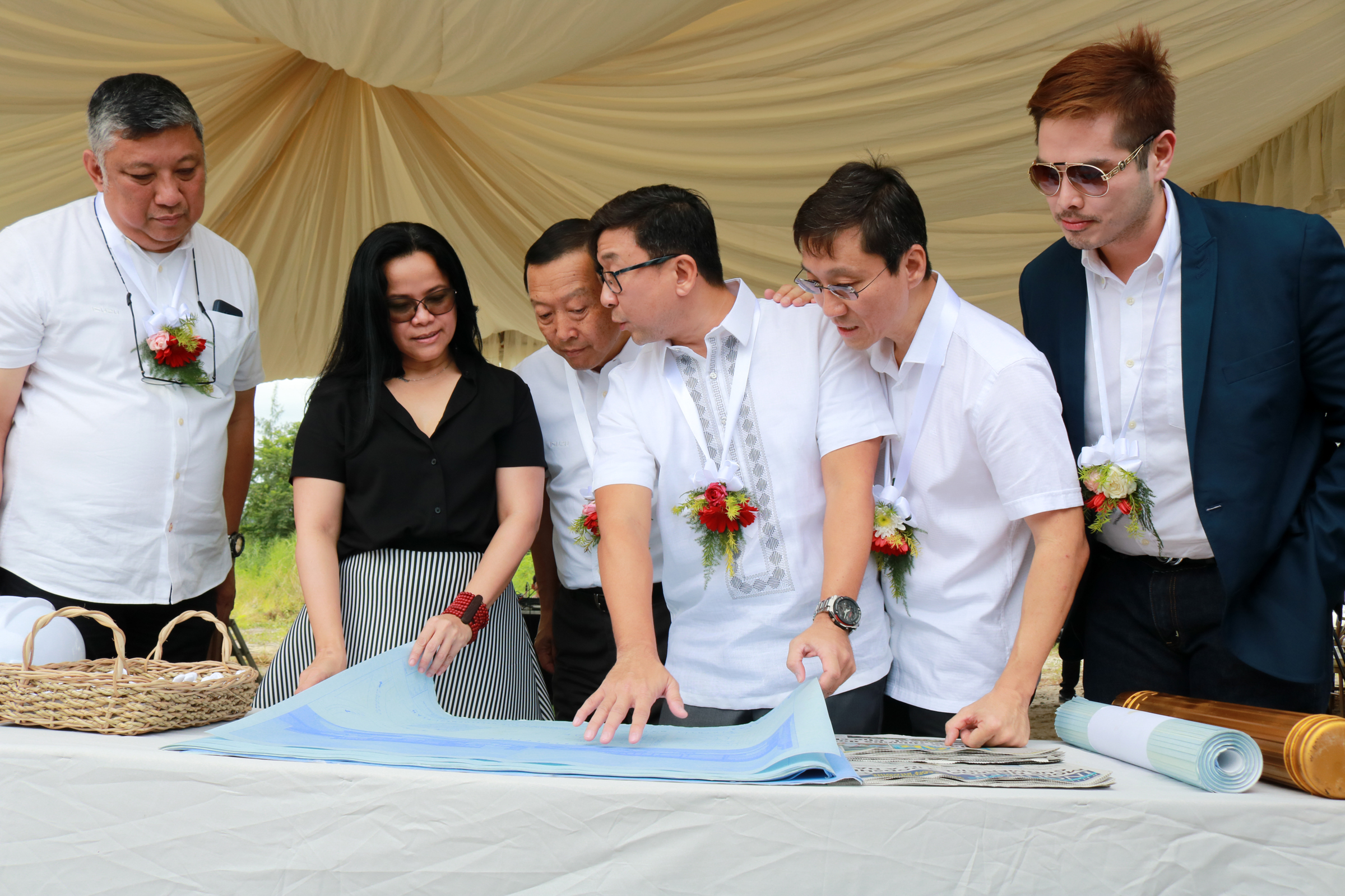 SBMA Chairman and Administrator Wilma T. Eisma views a blueprint for the proposed Isuzu Subic showroom during the project ground-breaking ceremony on Friday at the Subic Bay Gateway Park in the Subic Bay Freeport. Â Joining her are (left to right): Isuzu Phils. Sales Head Joseph Bautista, Isuzu Phils. President Hajime Koso, Velocity Motors President Jason Hao, Velocity Motors Director Jeffrey Hao Lin, and SBMA Senior Deputy Administrator for Business and Investment Renato Lee.