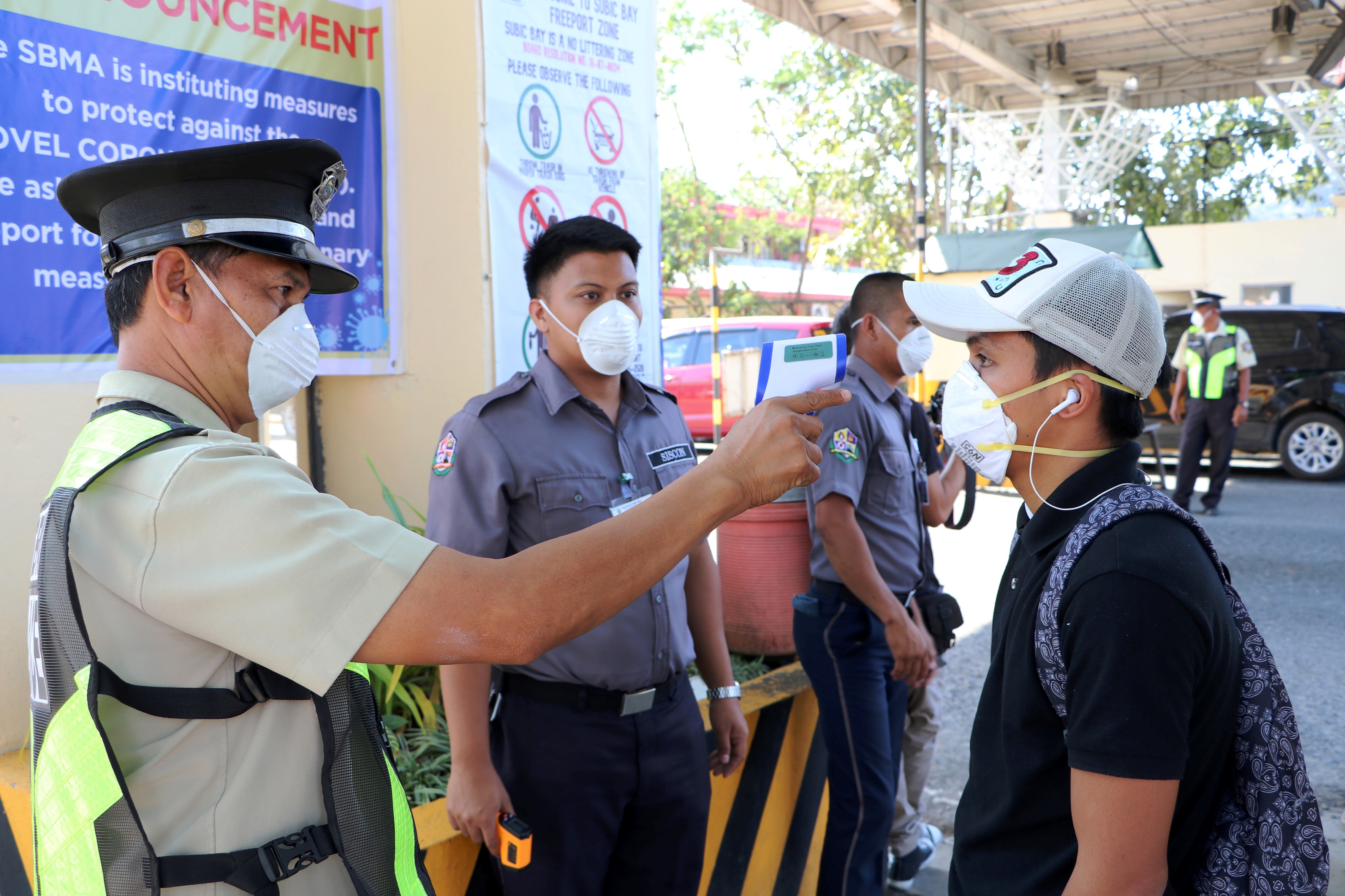 SBMA health personnel and security officers undertake temperature scanning at the Subic Bay Freeport Gates and public facilities