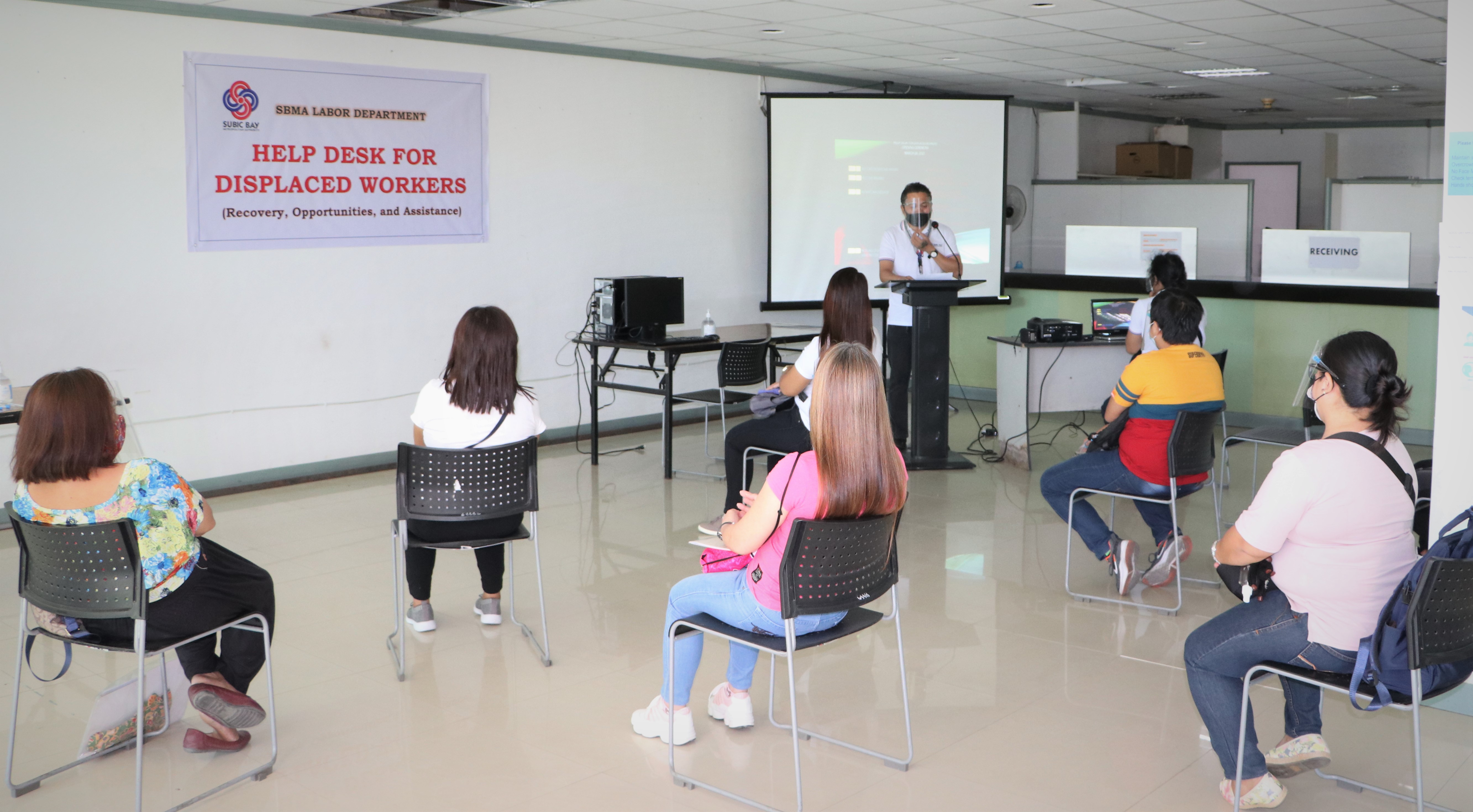 SBMA labor manager Melvin Varias explains the purpose and benefits of the SBMA Help Desk to displaced workers during the project launch on March 26