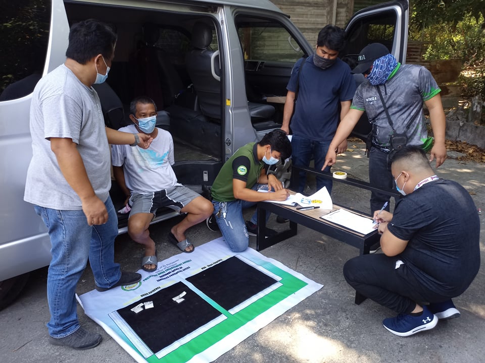 Operatives inspect suspected illegal drugs seized from Olongapo City resident Robert Balajadia, who was arrested during a drug buy-bust in the Subic Bay Freeport on Sunday, April 25.