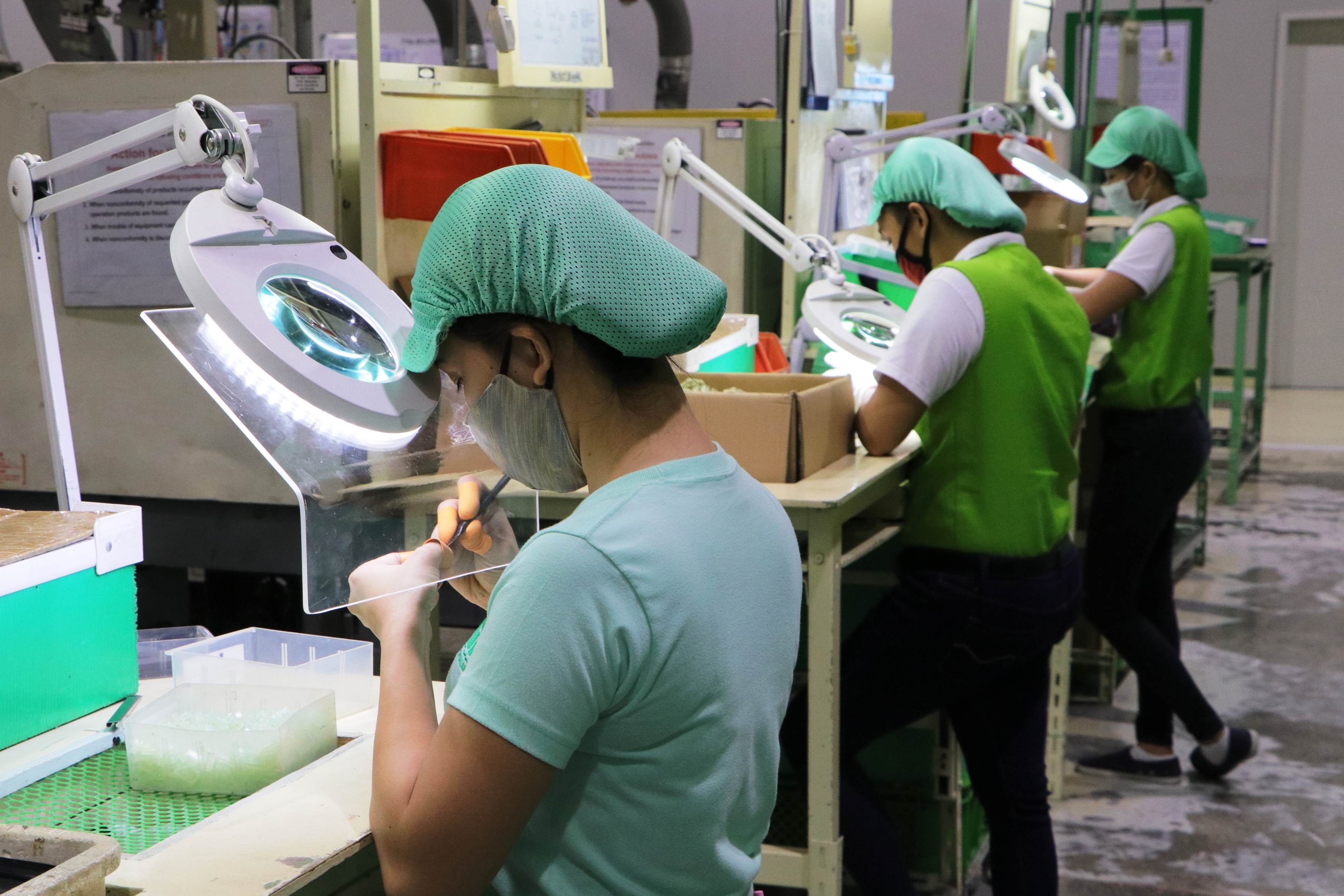 Workers at Sanyo Denki Philippines, Inc. assemble cooling fans used for ventilatorsâ€”one of Subicâ€™s top export products during the Covid-19 pandemic