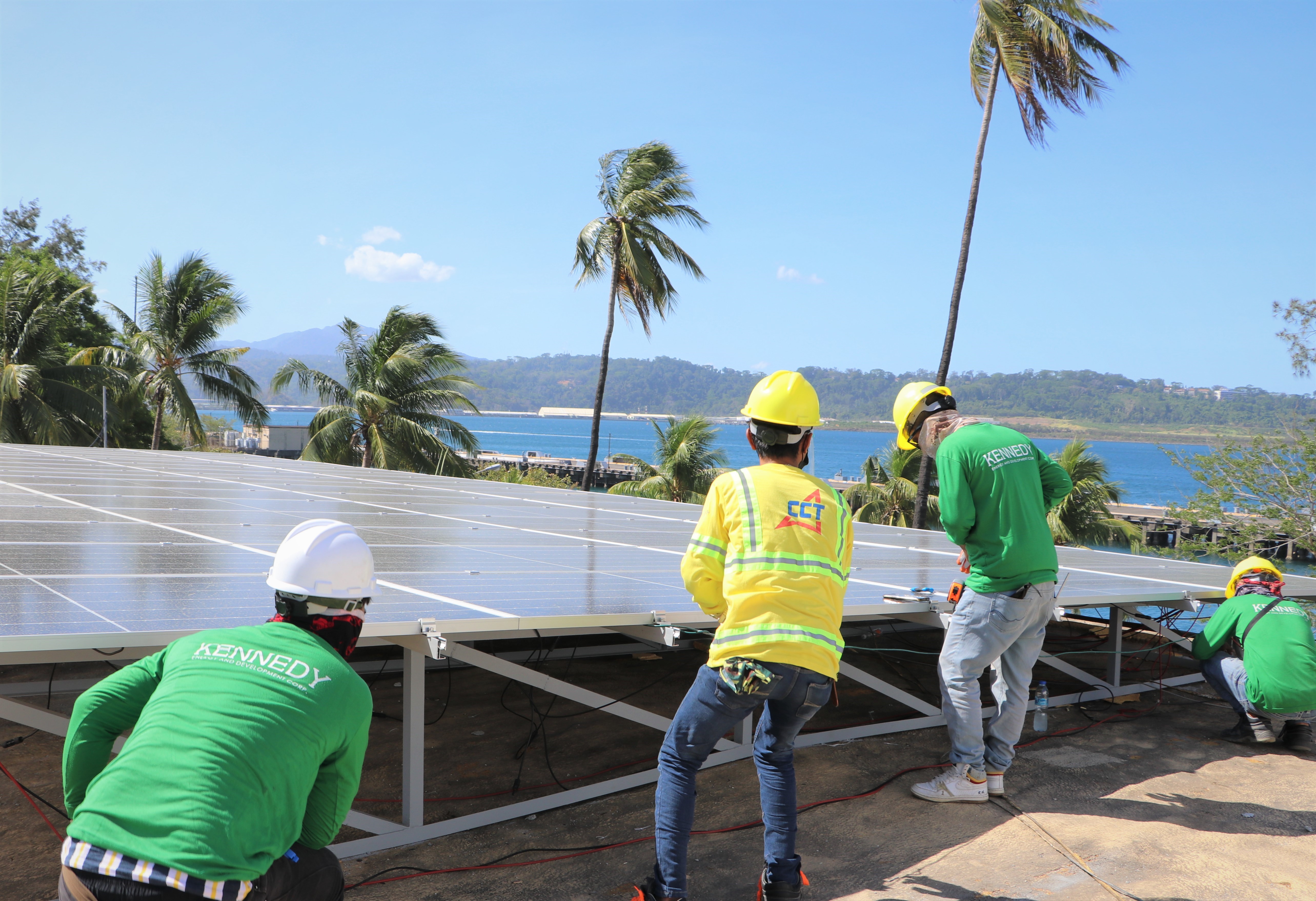 Technicians install solar panels at the rooftop of Bldg. 229, the SBMA administration building