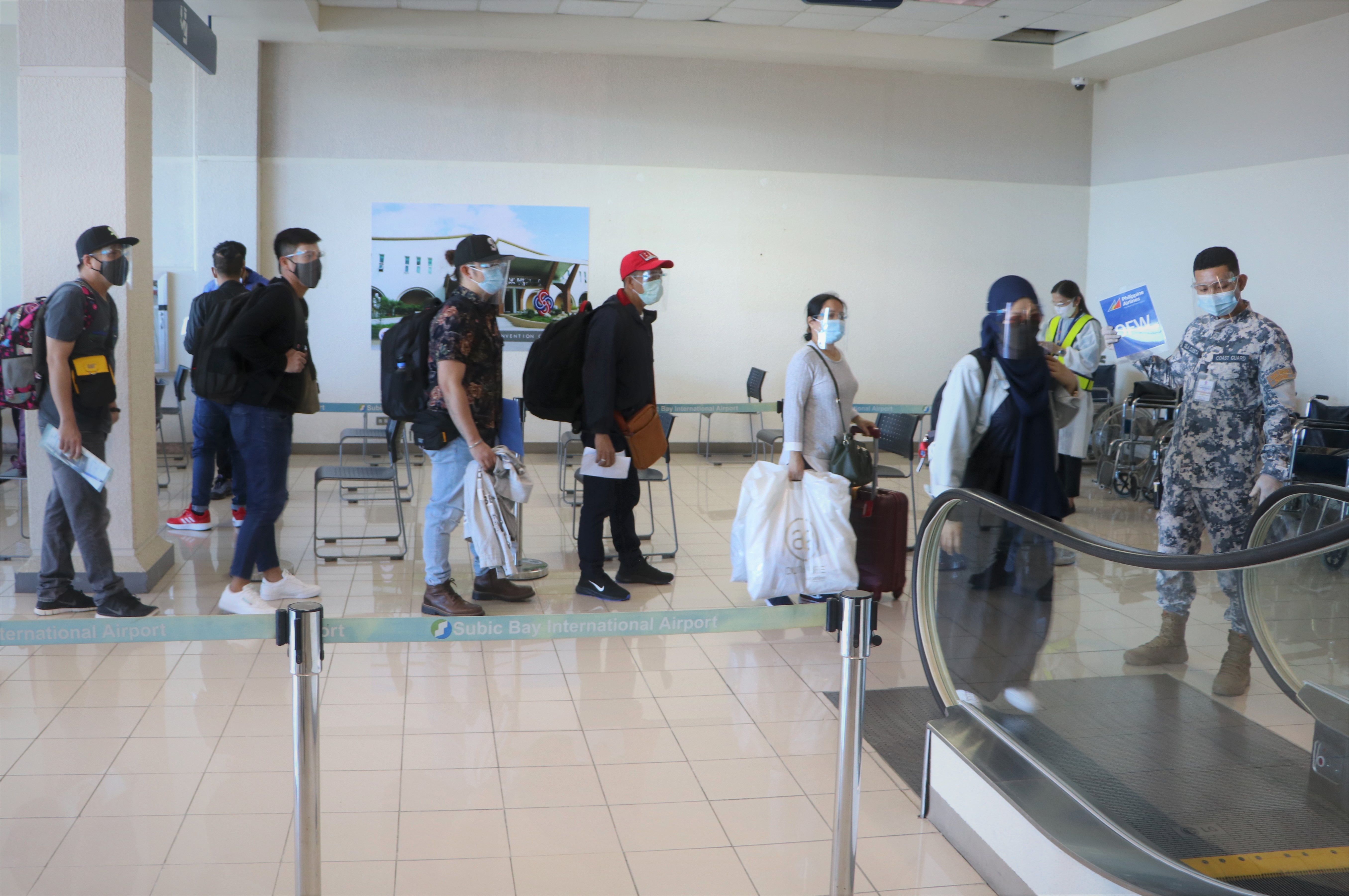 Returning OFWs are herded to the one-stop-shop processing area upon arrival art the Subic Bay International Airport on Wednesday
