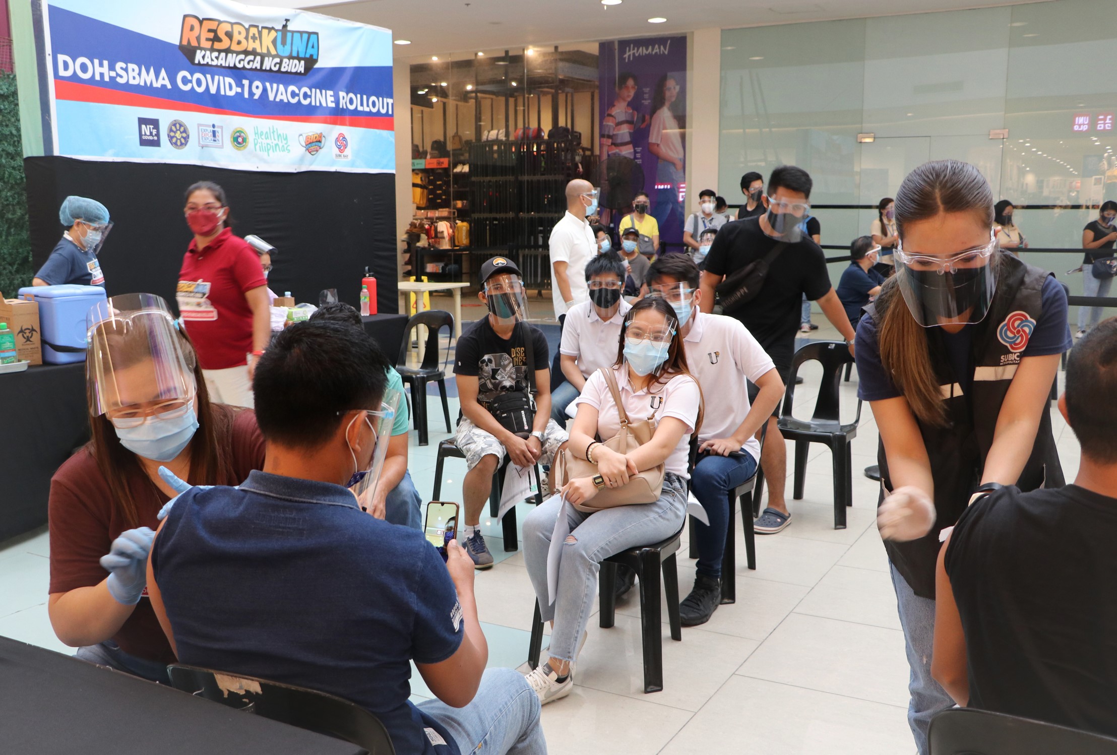 SBMA health workers administer the second dose of Sinovac vaccine to Freeport stakeholders on Monday during an inoculation project at Harbor Point Ayala Mall.