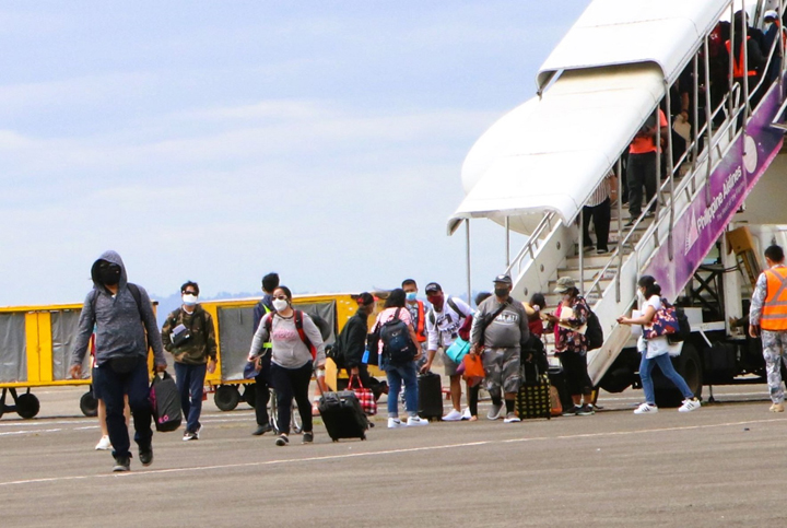 Returning Filipinos from Palau arrive on board the last OFW repatriation flight of the Philippine Airlines at the Subic Bay International Airport on Tuesday, Feb. 22