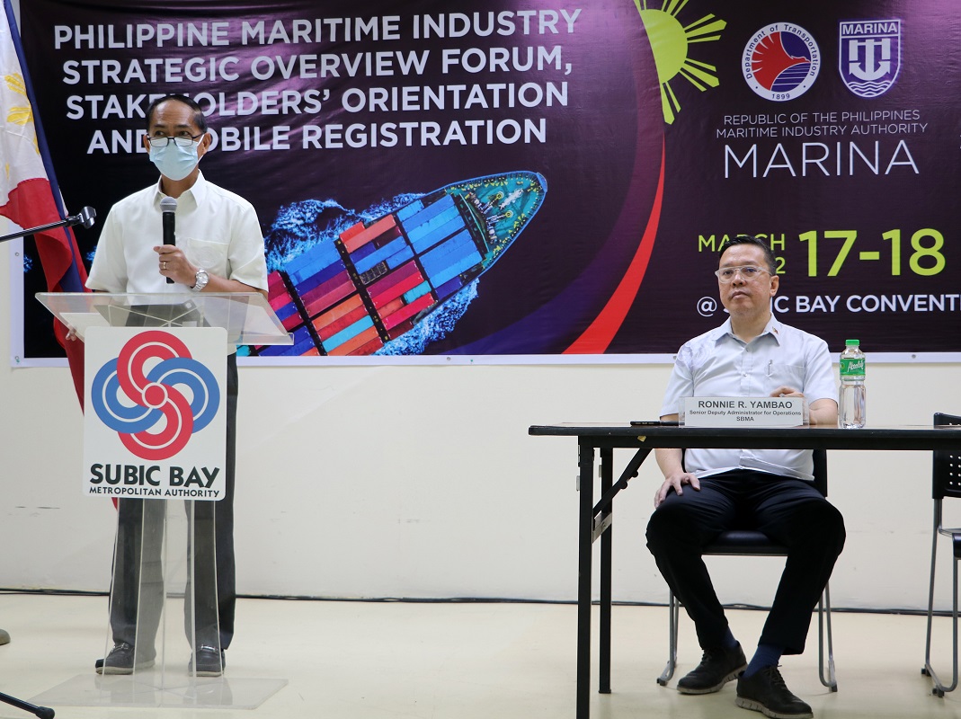Maritime Industry Authority (MARINA) administrator Robert Empedrad addresses the participants of the Philippine Maritime Industry Strategic Overview Forum for Stakeholders’ Orientation and mobile registration held at the Subic Bay Exhibition and Convention Center in Subic Bay Freeport zone. SBMA Senior Deputy Administrator Ronnie Yambao (seated, right), who welcomed the contingents, listens.