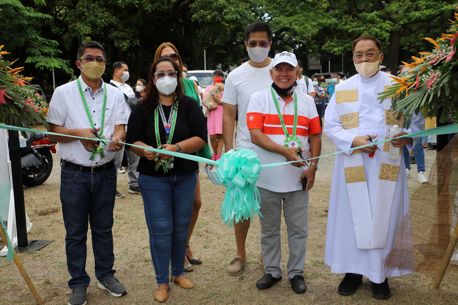 Subic Bay Metropolitan Authority (SBMA) Chairman Rolen C. Paulino (3 rd from left) leads the ribbon-cutting ceremony to formally open the Weekend Eco Market at the San Roque chapel grounds. With him is OIC-Provincial Director of the Department of Trade and Industry (DTI) Zambales Enrique Tacbad (left), SBMA Tourism manager Jem Camba (2 nd from left), and Fr. Jose Manuel Montes (right).