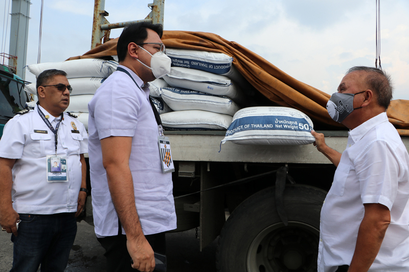 SBMA Chairman and Administrator Rolen C. Paulino confers with Customs Port of Subic Deputy Collector for Operations Giovanni Ferdinand Leynes and BoC Bay Services Unit Chief Leo Abella as they inspect parts of the sugar imported from Thailand during an inspection at MV Bangpakaew docked at the NSD wharf in Subic Bay Freeport.