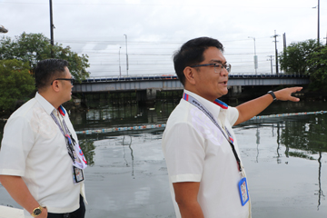SBMA Harbor Patrol chief Ador Fajardo (right) along with Law Enforcement Department head Alfredo Agustin Jr. (left) explains how the improvised garbage boom prevents trash from going out in the open sea.