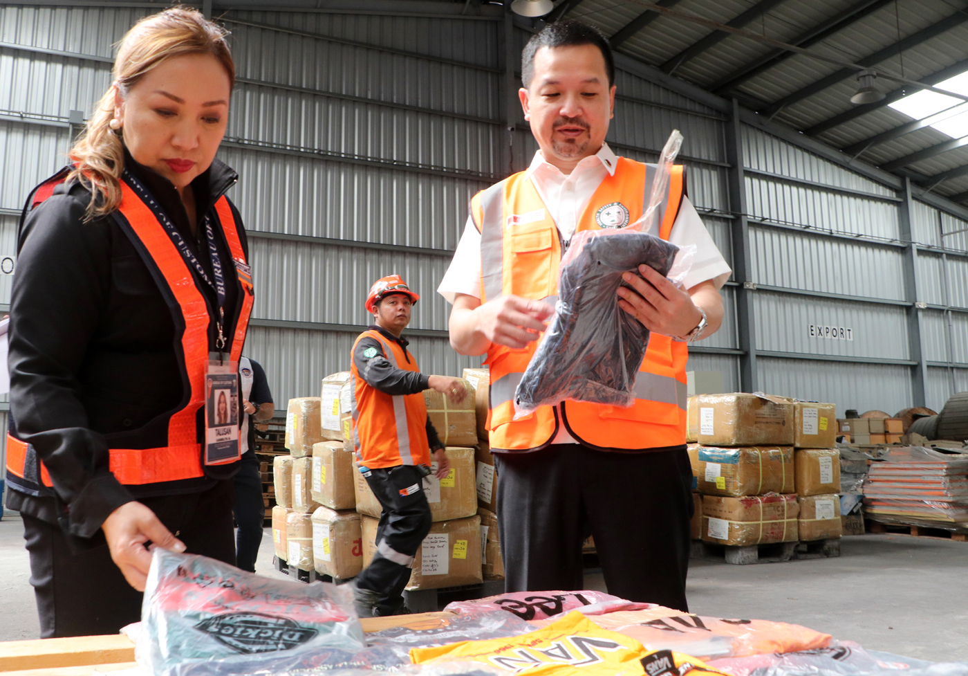Subic Bay Metropolitan Authority (SBMA) Chairman and Administrator Jonathan D. Tan joins Port of Subic district collector Carmelita Talusan during an inspection of the counterfeit items valued at PHP 240 million, which were intercepted by authorities over the weekend in the Subic Bay Freeport Zone.