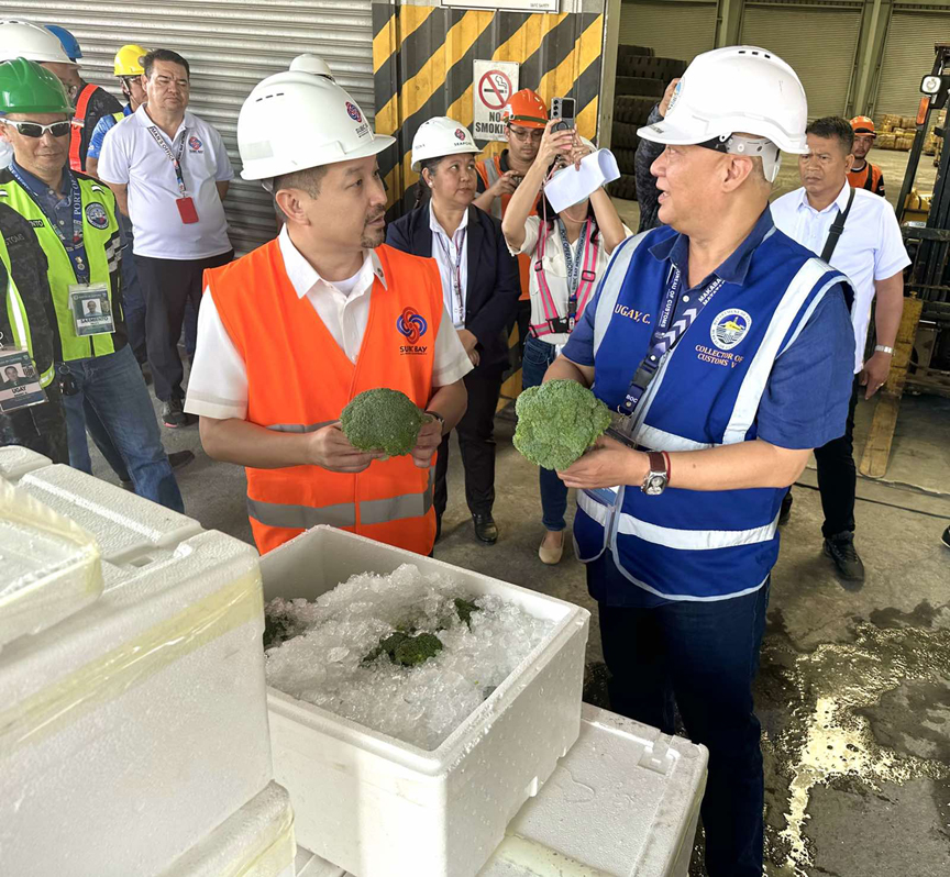 SBMA Chairman Jonathan Tan and Deputy Administrator for Ports Kris Roman, together with officials from the Bureau of Plant Industry and the Bureau of Customs pose for photo ops after having inspected the misdeclared shipment from China.